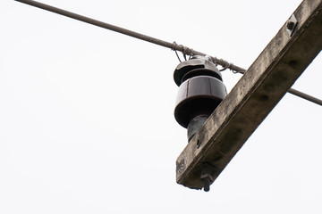 Aluminum wires placed on insulators wrapped with tie wire. Insulators are damaged, causing power...