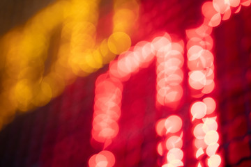 Out-of-focus effect, orange and red LED lights from the scoreboard. Suitable to be a background image.