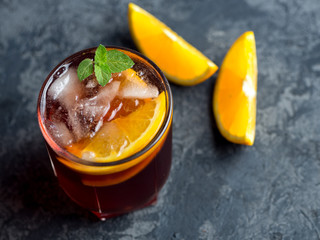 Negroni cocktail or sangria with ice, citrus and mint