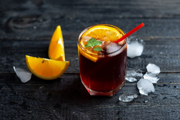 Negroni cocktail or sangria with ice, citrus and mint