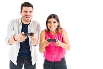 Young Couple Competing Each Other Against White Background