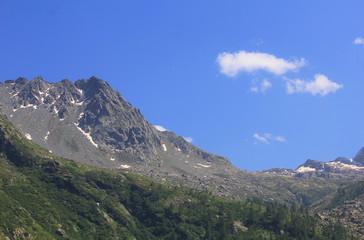 panorama with mountains, rocks, clouds and vegetation