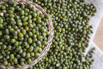 Mung bean seeds have long been used as food for human beings, green beans, seeds that are placed in a white plate, placed on a table with tears and tablecloths....