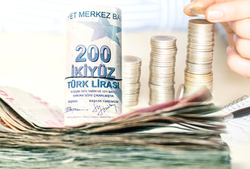 stacked turkish lira banknotes and coins