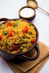 Tomato Rice also known as Tamatar Pilaf/pulav made using basmati rice, served in a bowl. selective focus