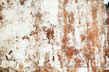 Old grungy bulleting board wall with remains of paper
