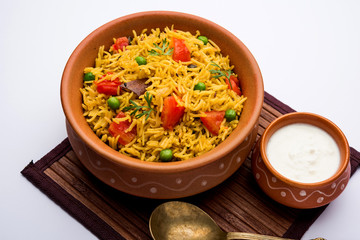 Tomato Rice also known as Tamatar Pilaf/pulav made using basmati rice, served in a bowl. selective focus