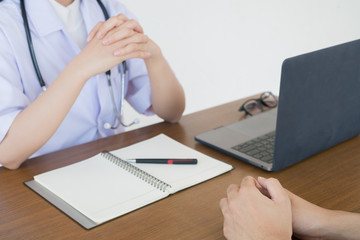 Doctor physician consulting with male patients in hospital exam room. Men's health concept