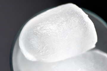 Close up macro image of ice cubes. Melting surface texture pattern detailed. Grainy. Holes. Inside...