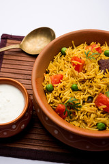 Tomato Rice also known as Tamatar Pilaf/pulav made using basmati rice, served in a bowl. selective focus