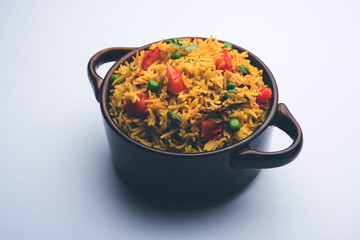 Tomato Rice also known as Tamatar Pilaf/pulav made using basmati rice, served in a bowl. selective focus