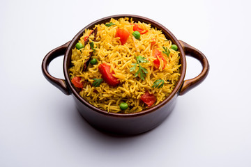 Tomato Rice also known as Tamatar Pilaf/pulav made using basmati rice, served in a bowl. selective focus