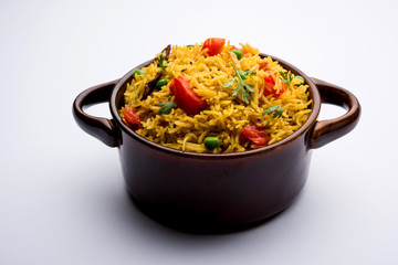 Tomato Rice also known as Tamatar Pilaf/pulav made using basmati rice, served in a bowl. selective focus