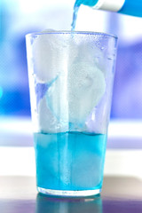 Generic blue berry syrup cocktail image. Close-up view water drops details. Cold drink for hot summer vacation holidays. Alcoholic drinks Blue Lagoon, Frostbite, Margarita, Hawaiian, Sapphire, Curacao
