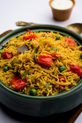 Tomato Rice also known as Tamatar Pilaf/pulav made using basmati rice, served in a bowl. selective focus