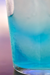 Generic blue berry syrup cocktail image. Close-up view water drops details. Cold drink for hot summer vacation holidays. Alcoholic drinks Blue Lagoon, Frostbite, Margarita, Hawaiian, Sapphire, Curacao