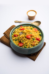 Tomato Rice also known as Tamatar Pilaf/pulav made using basmati rice, served in a bowl. selective focus