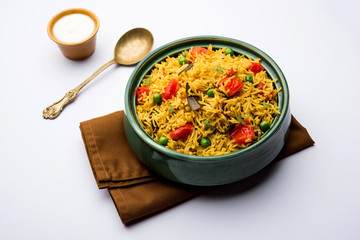 Tomato Rice also known as Tamatar Pilaf/pulav made using basmati rice, served in a bowl. selective focus