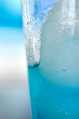 Naklejka na ściany i meble Generic blue berry syrup cocktail image. Close-up view water drops details. Cold drink for hot summer vacation holidays. Alcoholic drinks Blue Lagoon, Frostbite, Margarita, Hawaiian, Sapphire, Curacao