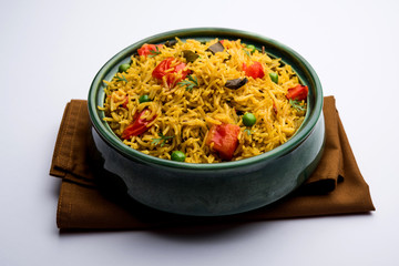 Tomato Rice also known as Tamatar Pilaf/pulav made using basmati rice, served in a bowl. selective focus
