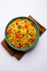 Tomato Rice also known as Tamatar Pilaf/pulav made using basmati rice, served in a bowl. selective focus