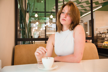 Girl is waiting for a meeting in cafe