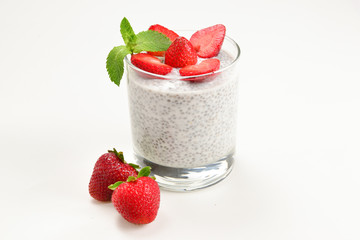 Chia pudding with strawberry and mint on a white background. Space for text or design.