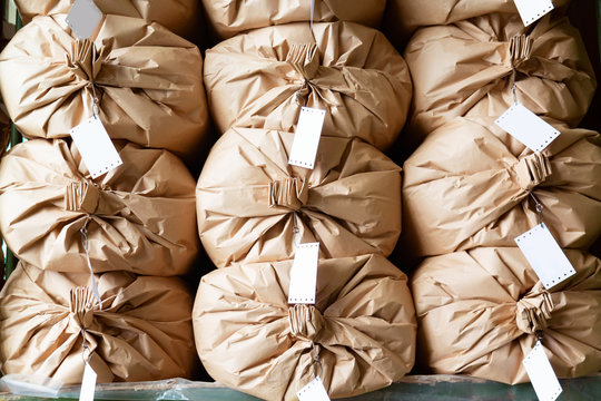 Warehouse concept. Stacked paper sacks in a warehouse.