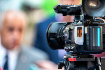 Press Conference Outdoors. Camera at a Media Event