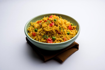 Tomato Rice also known as Tamatar Pilaf/pulav made using basmati rice, served in a bowl. selective focus