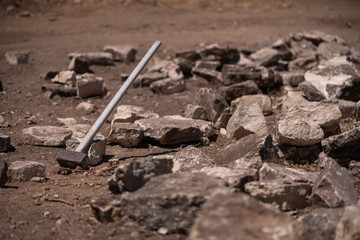 A very big hammer used to break stone for constrtuction