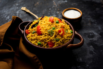 Tomato Rice also known as Tamatar Pilaf/pulav made using basmati rice, served in a bowl. selective focus