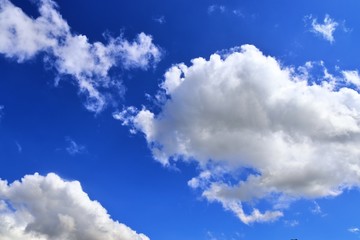 Beautiful white cumulus clouds on a deep blue sky