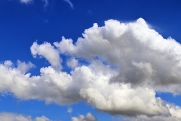 Beautiful white cumulus clouds on a deep blue sky