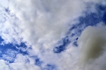 Beautiful white cumulus clouds on a deep blue sky