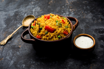 Tomato Rice also known as Tamatar Pilaf/pulav made using basmati rice, served in a bowl. selective focus