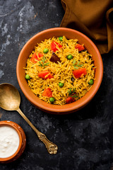 Tomato Rice also known as Tamatar Pilaf/pulav made using basmati rice, served in a bowl. selective focus