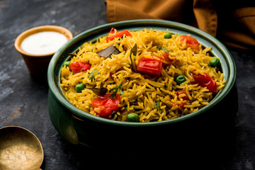 Tomato Rice also known as Tamatar Pilaf/pulav made using basmati rice, served in a bowl. selective focus