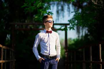 Portrait of a young businessman wearing a white shirt and sunglasses. Confident man makes plans for the future.