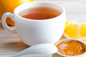 Cup of tea served with orange jam