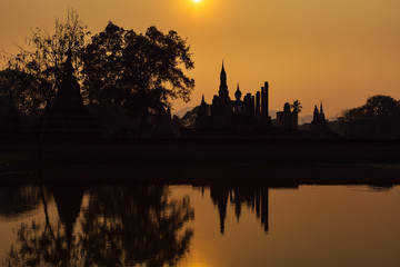 Wat Maha That temple against sunset, Sukhothai, Thailand