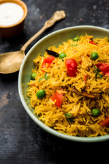 Tomato Rice also known as Tamatar Pilaf/pulav made using basmati rice, served in a bowl. selective focus