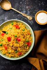 Tomato Rice also known as Tamatar Pilaf/pulav made using basmati rice, served in a bowl. selective focus