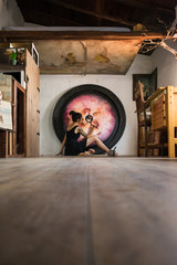 Painter finishes her great painting lying on the floor