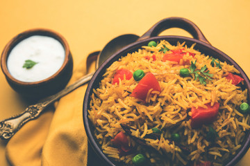 Tomato Rice also known as Tamatar Pilaf/pulav made using basmati rice, served in a bowl. selective focus