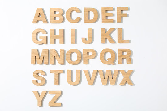 Wooden letters of English alphabet on white background, top view - Powered by Adobe
