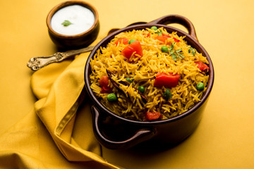 Tomato Rice also known as Tamatar Pilaf/pulav made using basmati rice, served in a bowl. selective focus
