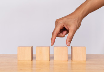 Hand choose empty wooden blocks on white background. Concept of decision making and choices success in the future goal