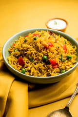 Tomato Rice also known as Tamatar Pilaf/pulav made using basmati rice, served in a bowl. selective focus