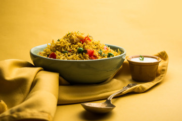 Tomato Rice also known as Tamatar Pilaf/pulav made using basmati rice, served in a bowl. selective focus